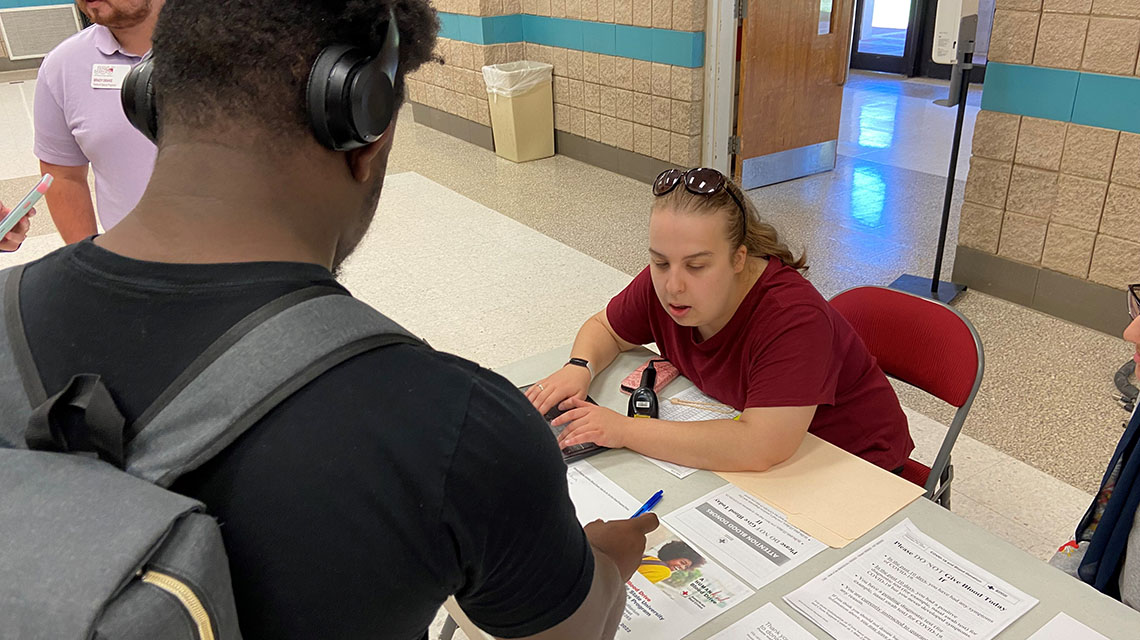 Honors students man the desk at the blood drive